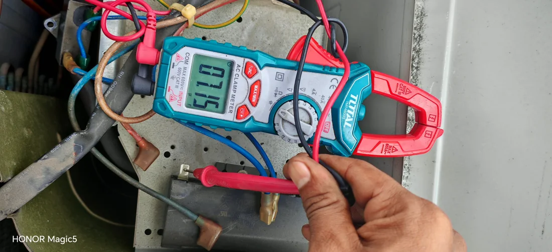 Electrical measurements being taken inside an air conditioning system
