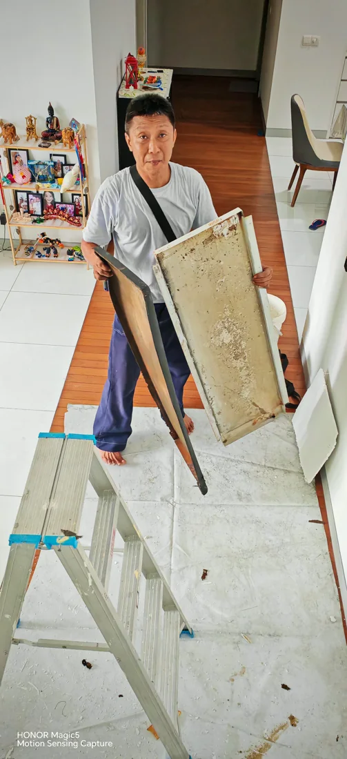A SKN RAKAN technician at work with removed air conditioning panels