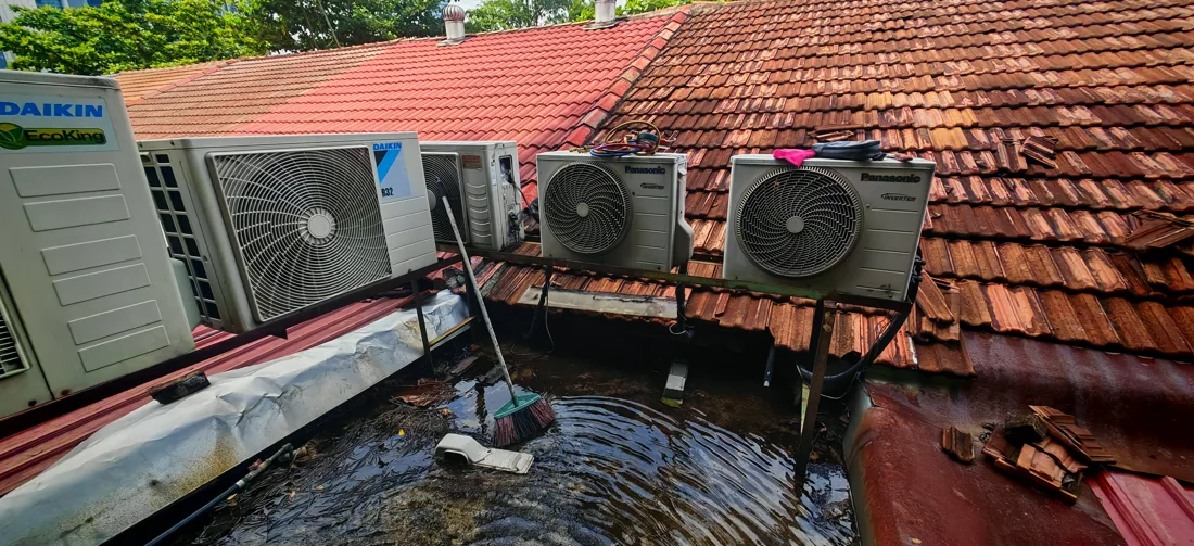 Outdoor air conditioning condenser units on a tiled roof